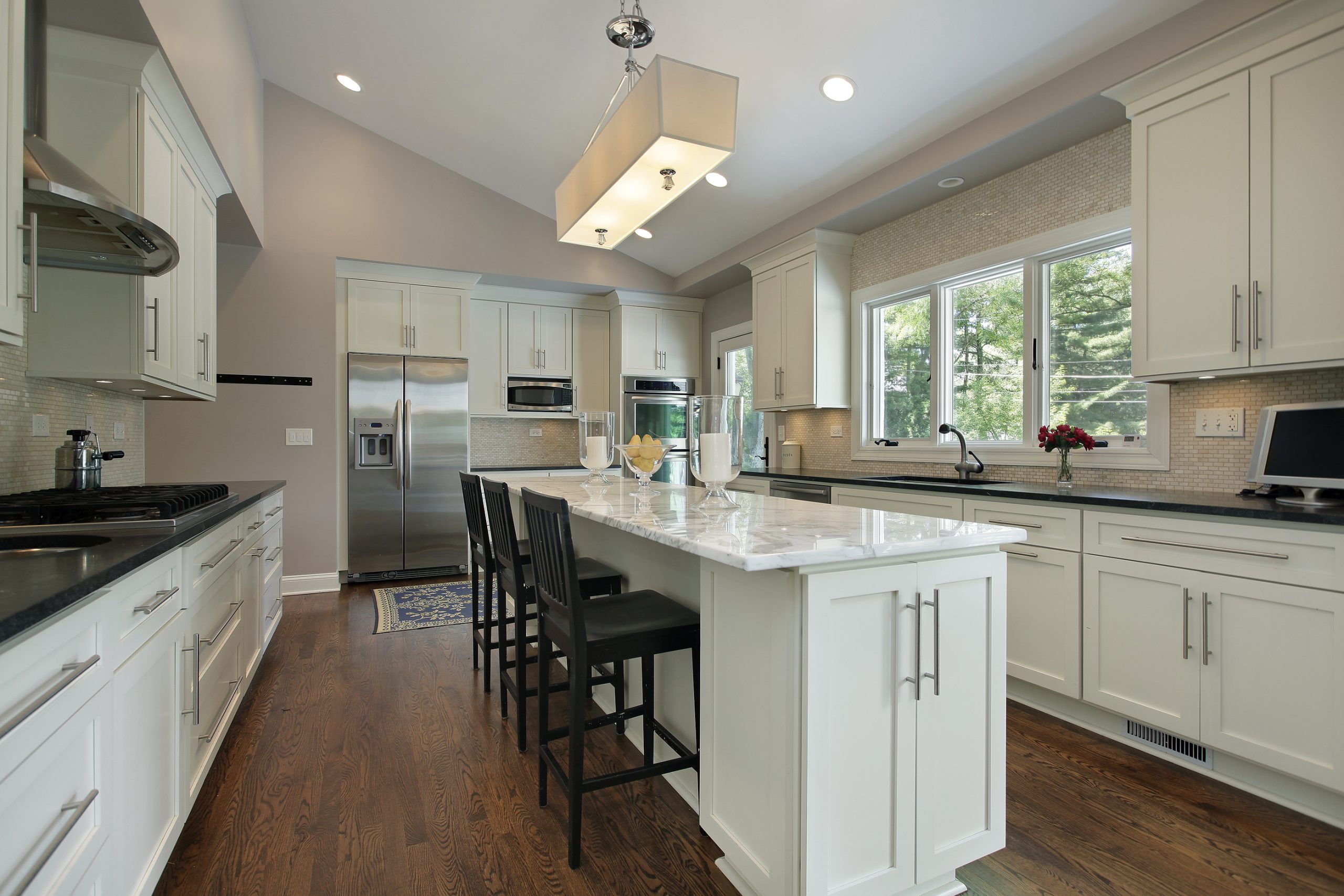 Luxury kitchen remodel with white cabinets and a large island. 