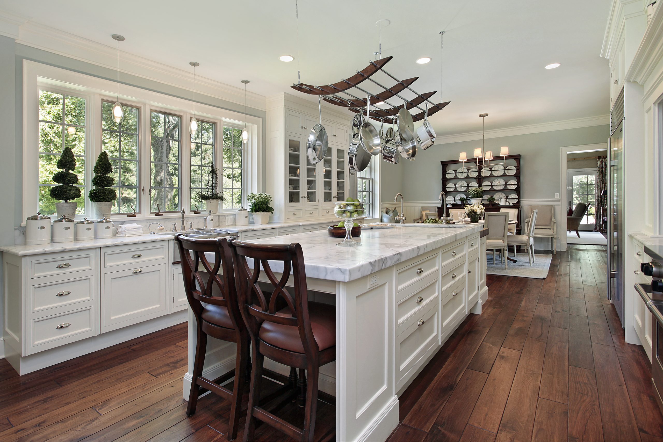 Luxury kitchen with white cabinets and large island. 