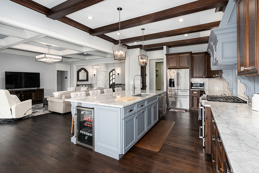 Remodeled kitchen with white cabinets and a large granite island. 